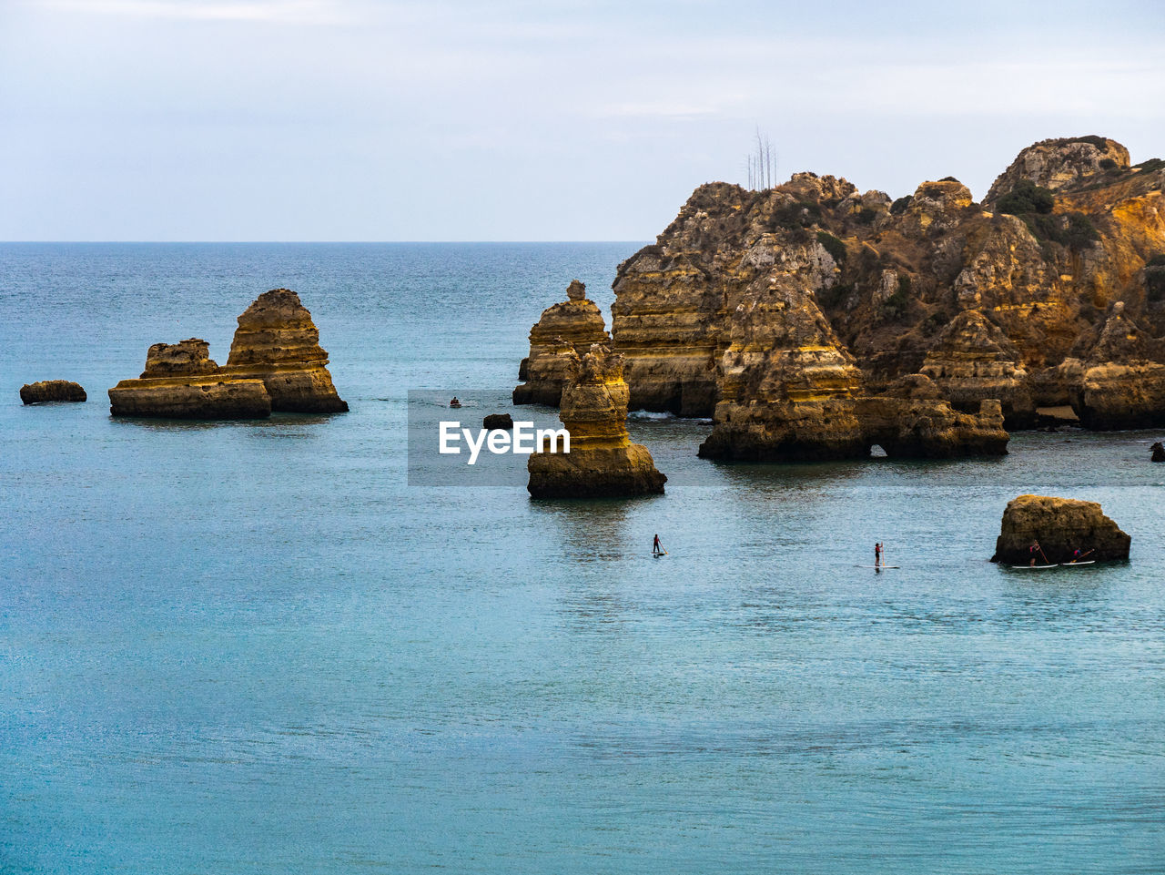 Scenic view of rocks in sea against sky