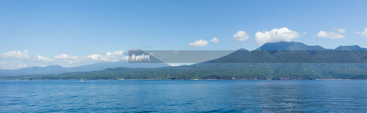 SCENIC VIEW OF SEA AND MOUNTAIN AGAINST SKY