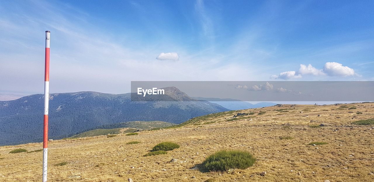 SCENIC VIEW OF MOUNTAINS AGAINST BLUE SKY