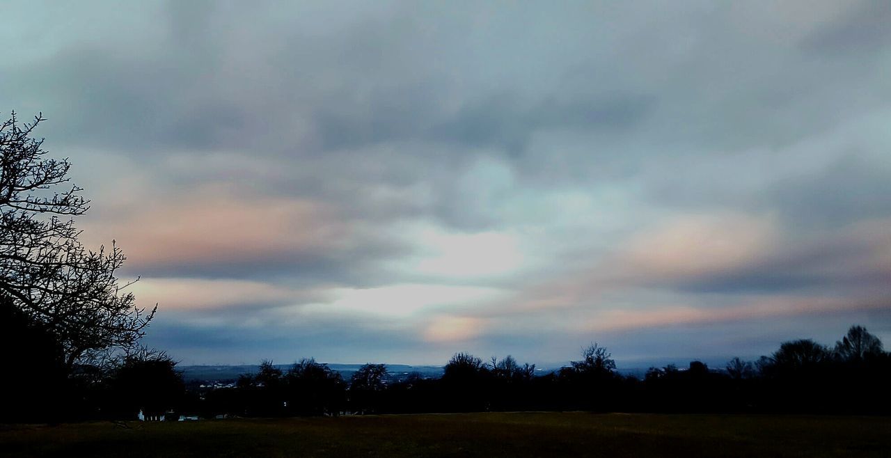 SCENIC VIEW OF SILHOUETTE FIELD AGAINST SKY AT SUNSET