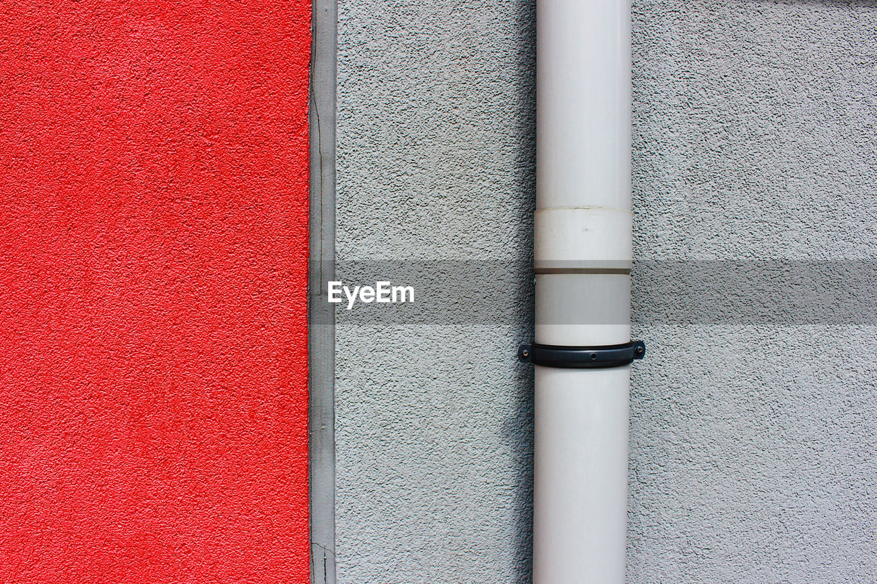 CLOSE-UP OF PIPE ON CONCRETE WALL