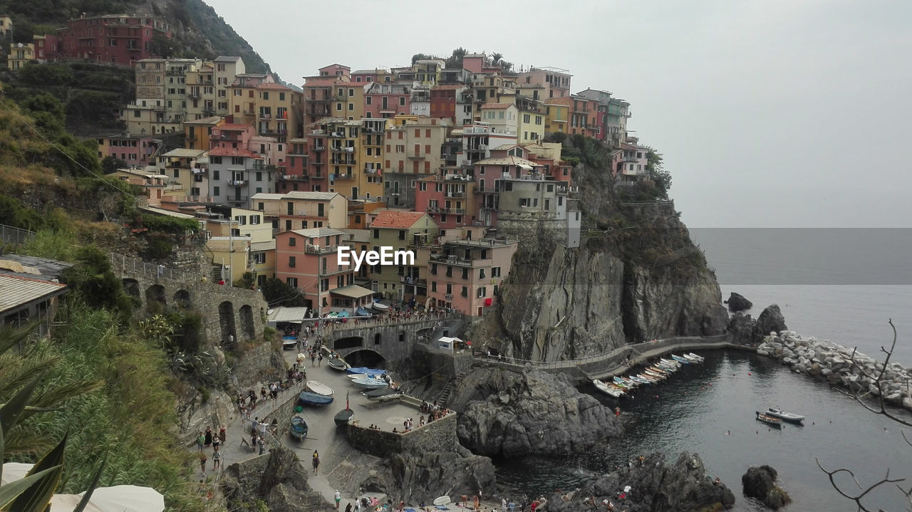 High angle view of town by sea against sky