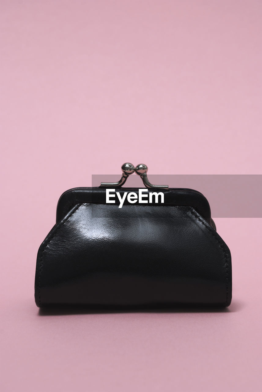 Close-up of purse against pink background