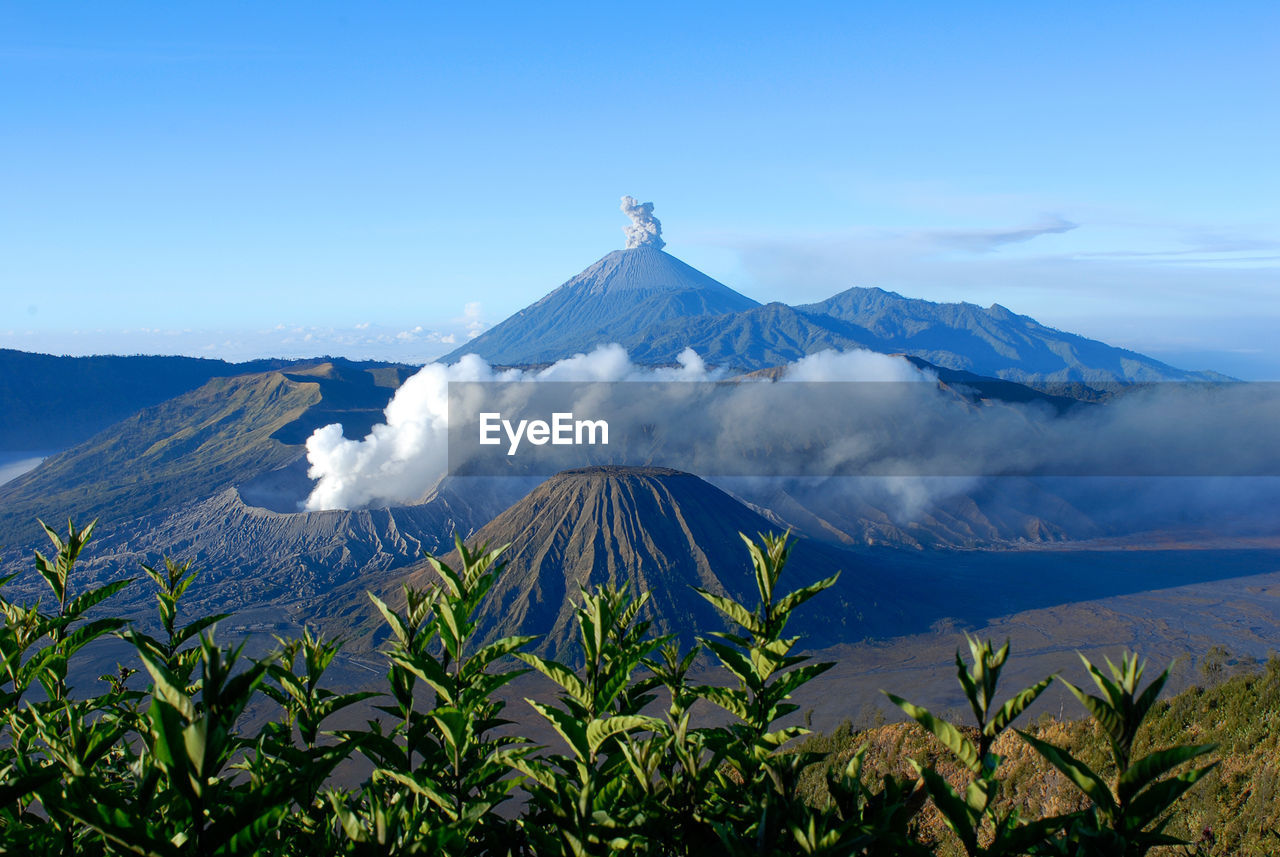 View of volcanic mountain range against blue sky