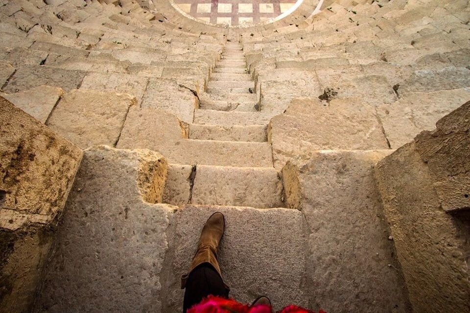 personal perspective, one person, low section, human body part, human leg, shoe, history, real people, ancient, men, one man only, day, old ruin, standing, adults only, only men, adult, ancient civilization, outdoors, architecture, people