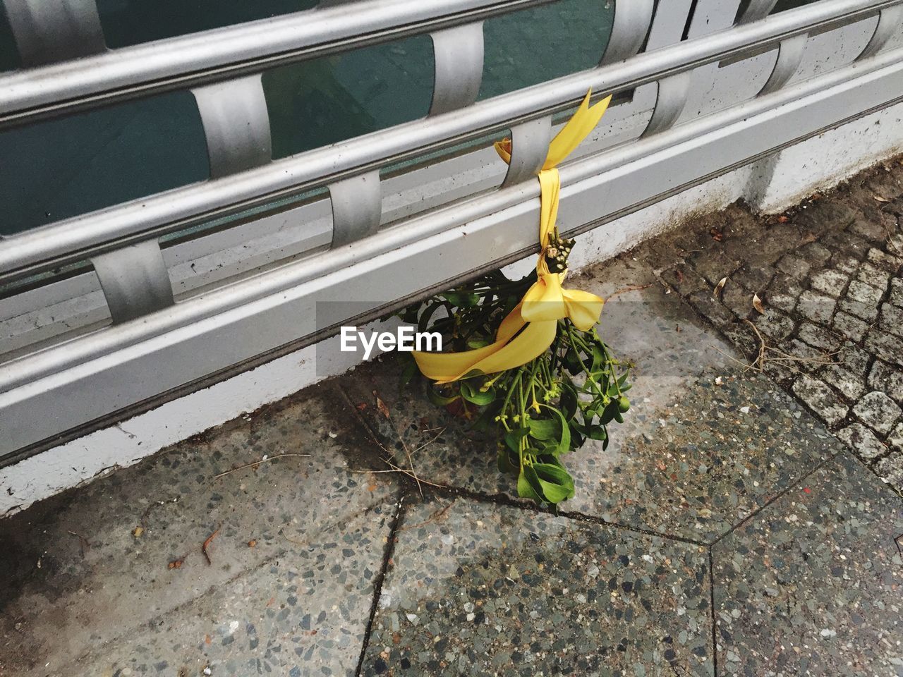 Bush of flowers tied up ribbon on railing