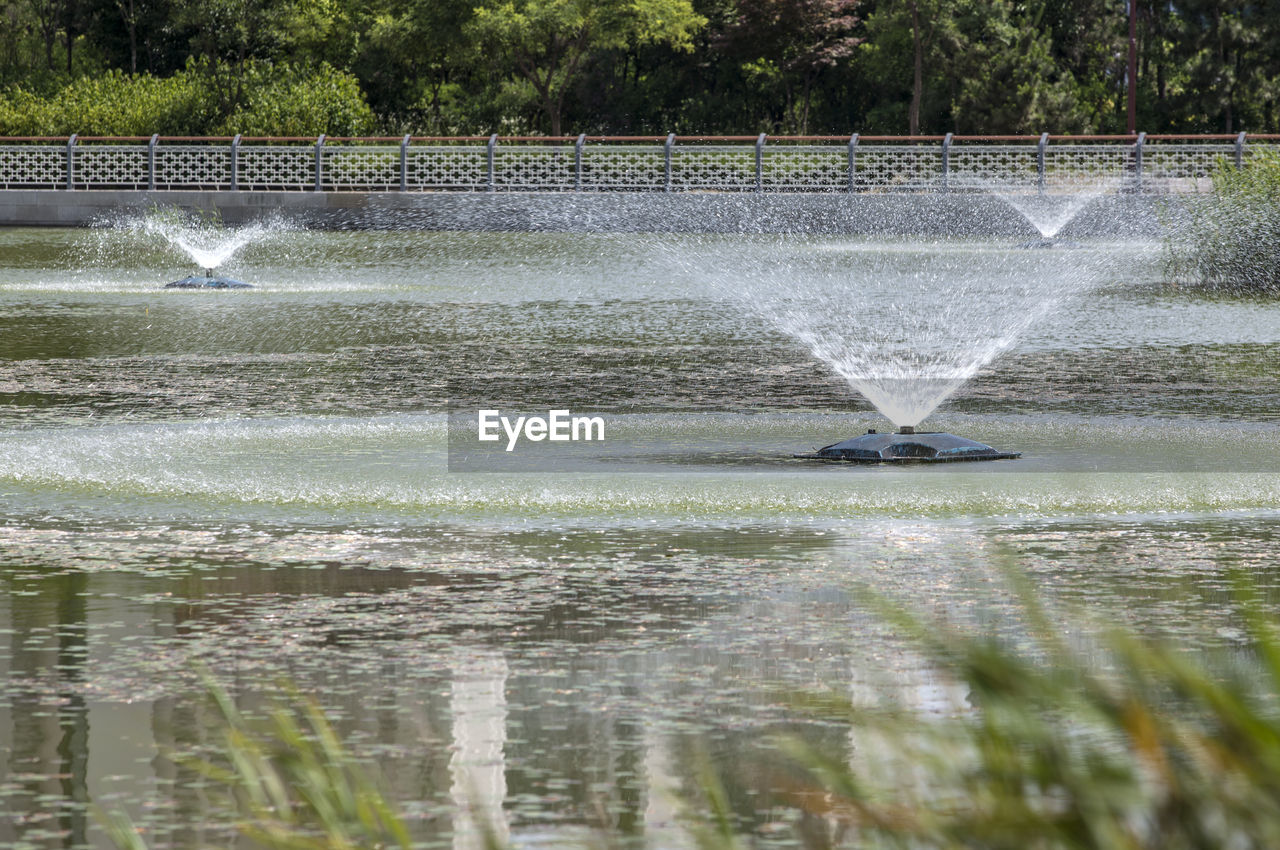 Fountains on pond in park