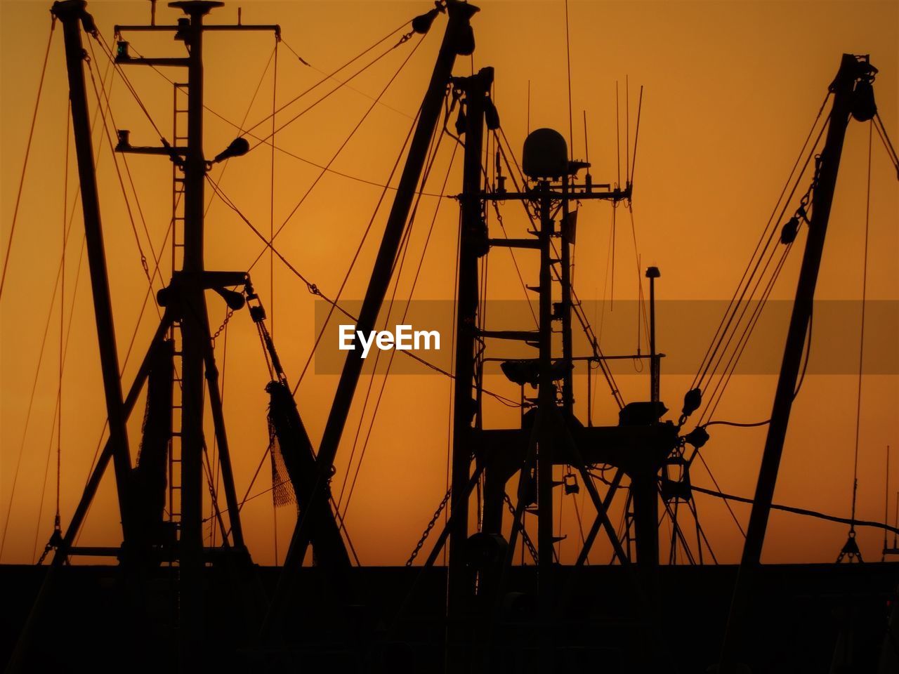 Ufishing trawlers against sky during sunset in büsum harbour