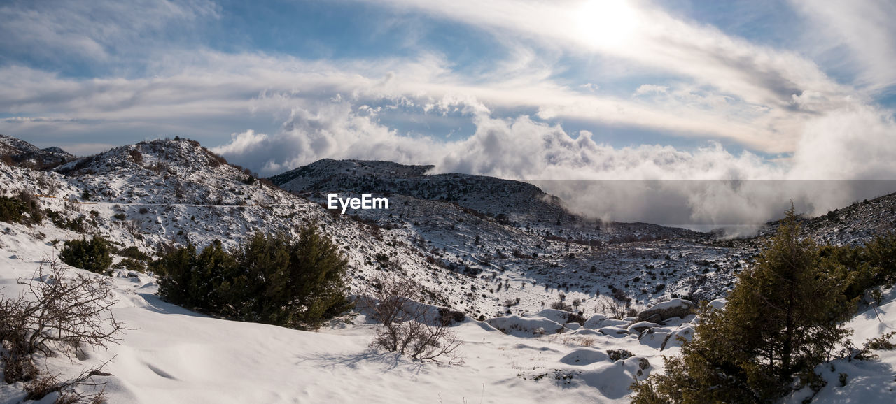 Scenic view of snow covered mountains against sky