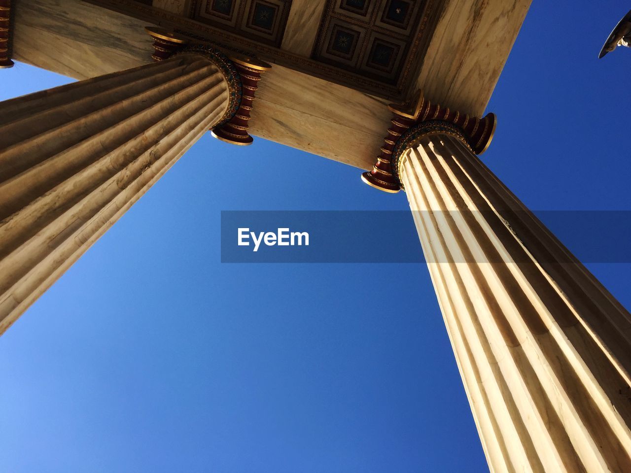 Academy of athens columns against clear blue sky