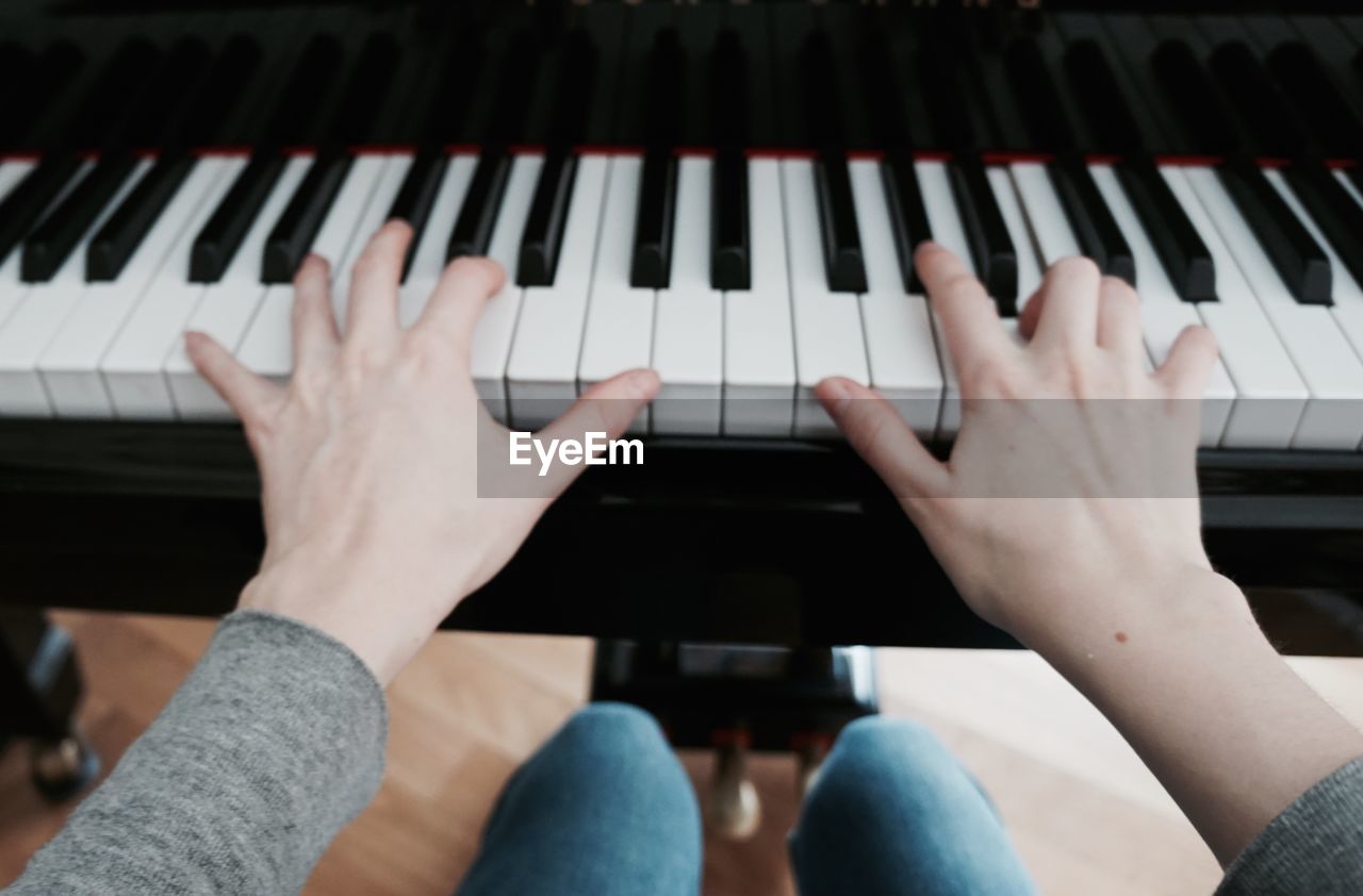 Close-up of woman playing piano