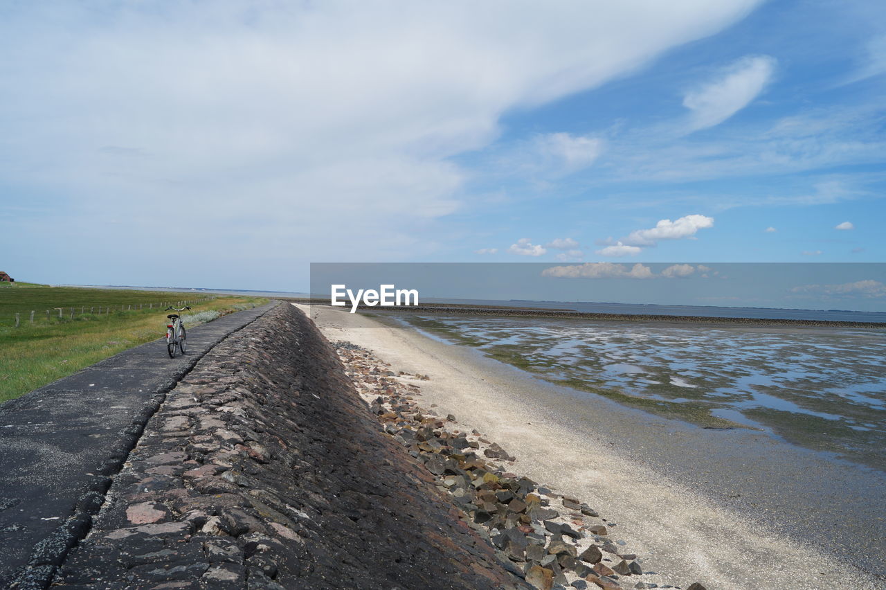 Road by sea against sky