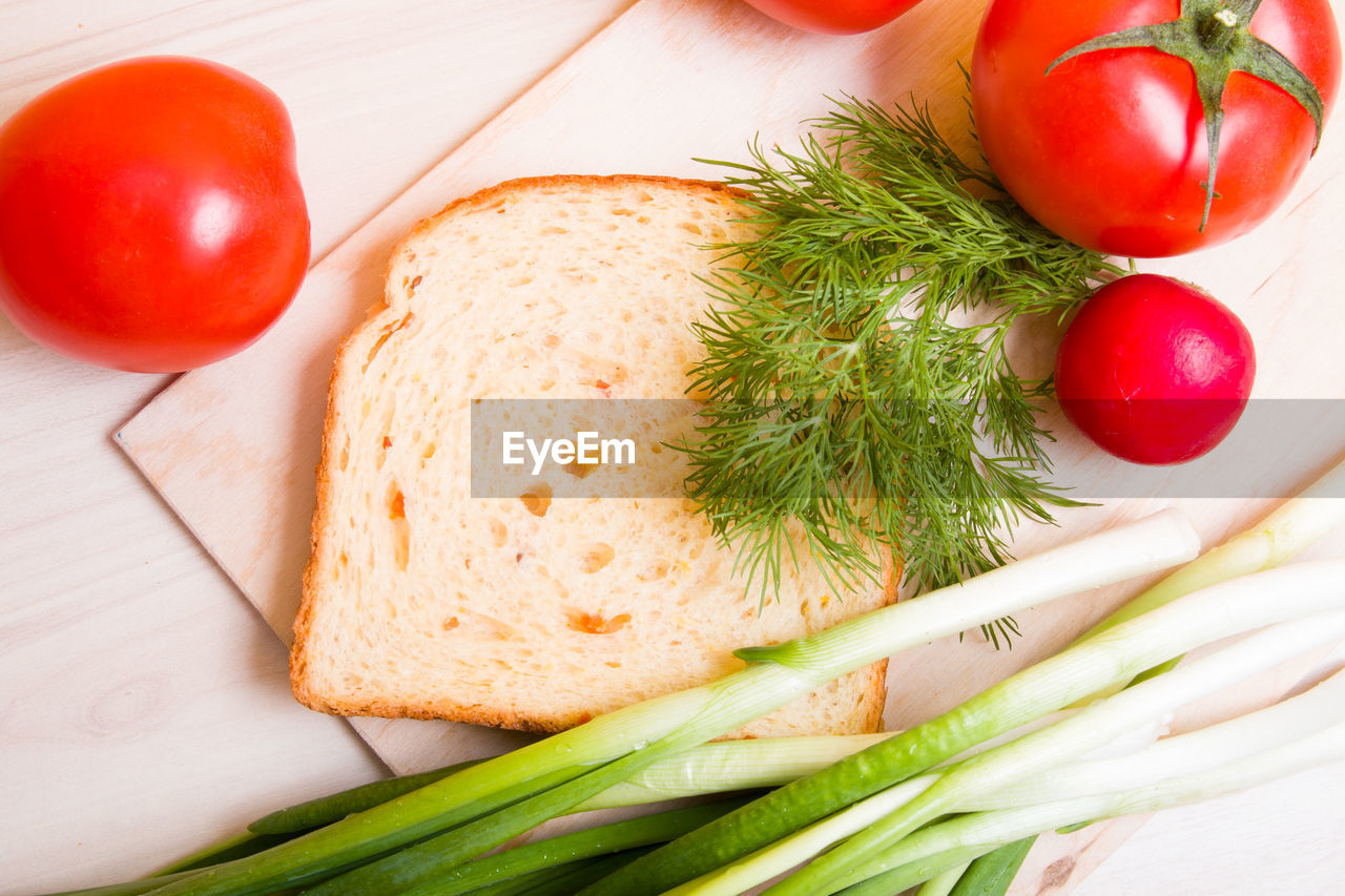 Piece of bread and vegetables for a vegan sandwich, healthy breakfast concept