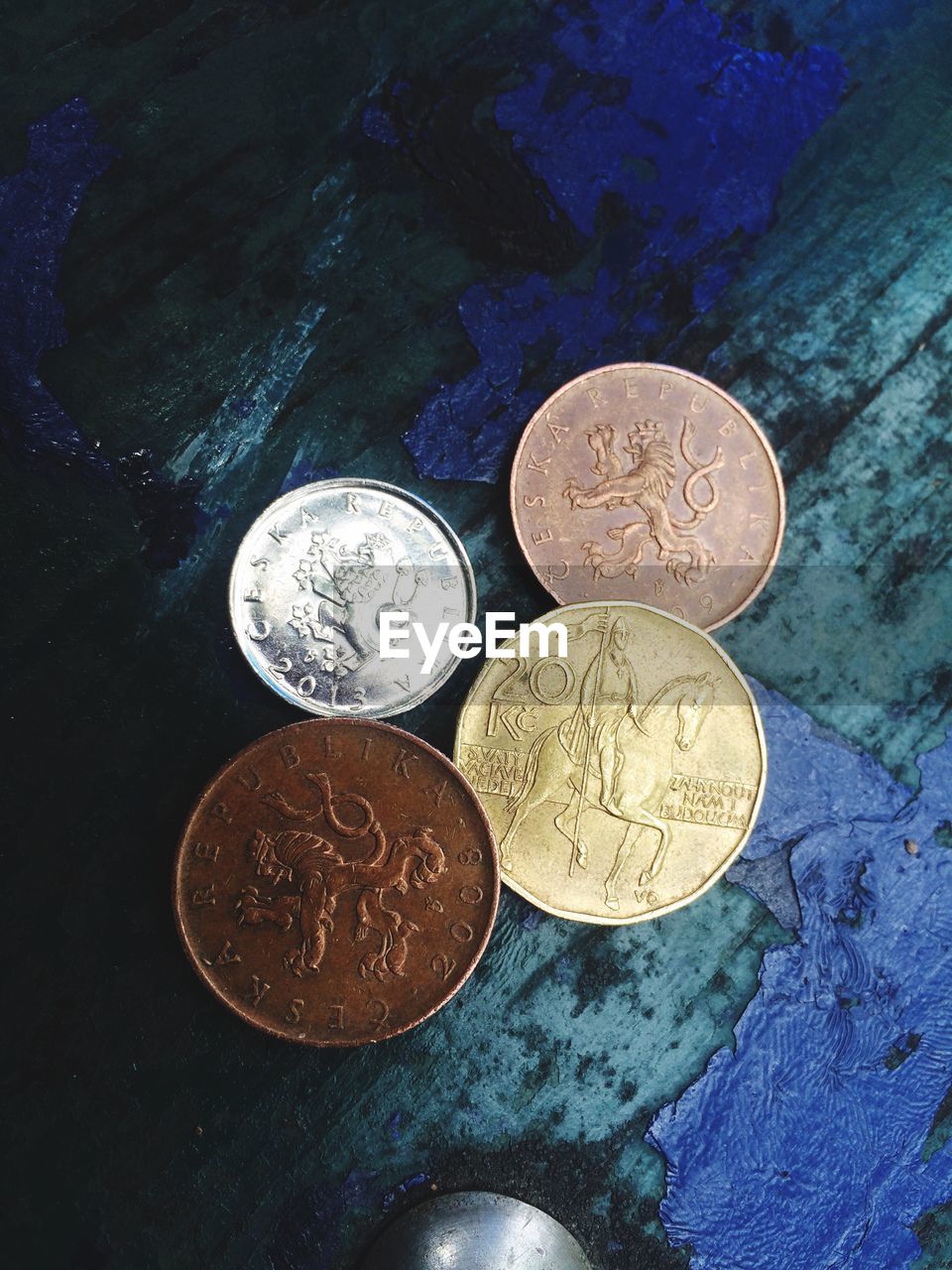 HIGH ANGLE VIEW OF COINS ON METAL TABLE