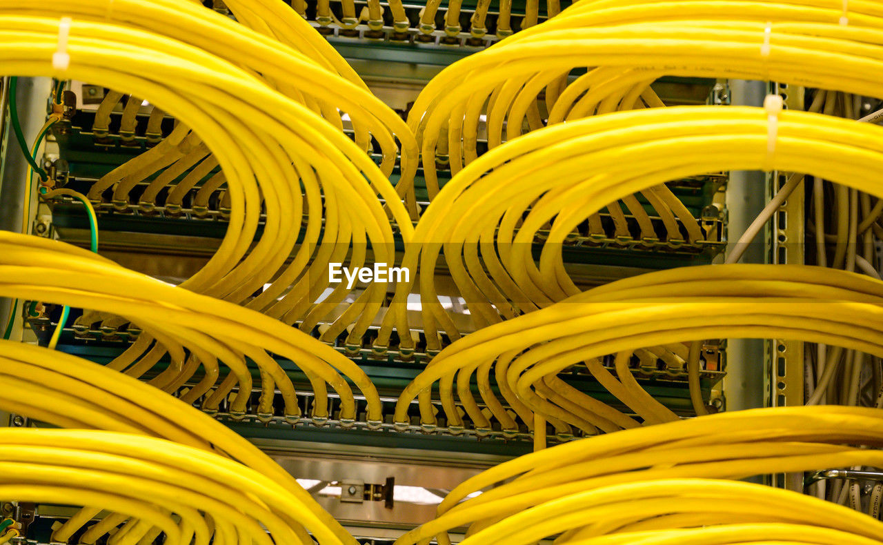 yellow, internet, technology, computer network, cable, computer cable, network server, communication, wireless technology, network connection plug, no people, electricity, computer, line, business, indoors, industry, electrical supply