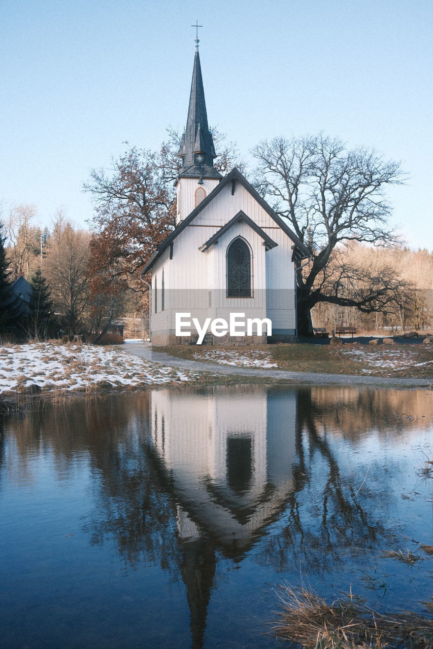 Old wooden church in misery is reflected in the water, district of harz