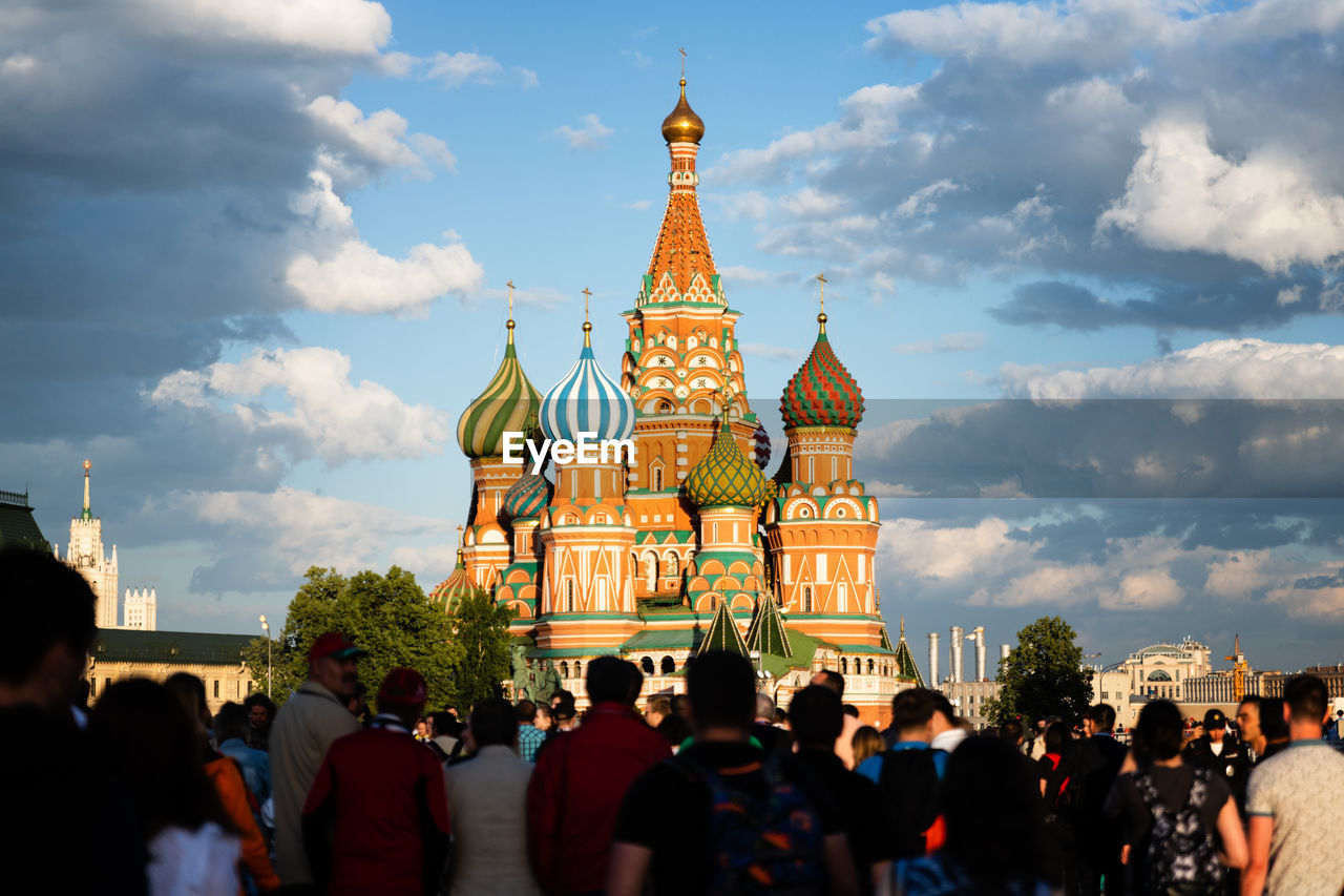 People standing in front of church against sky