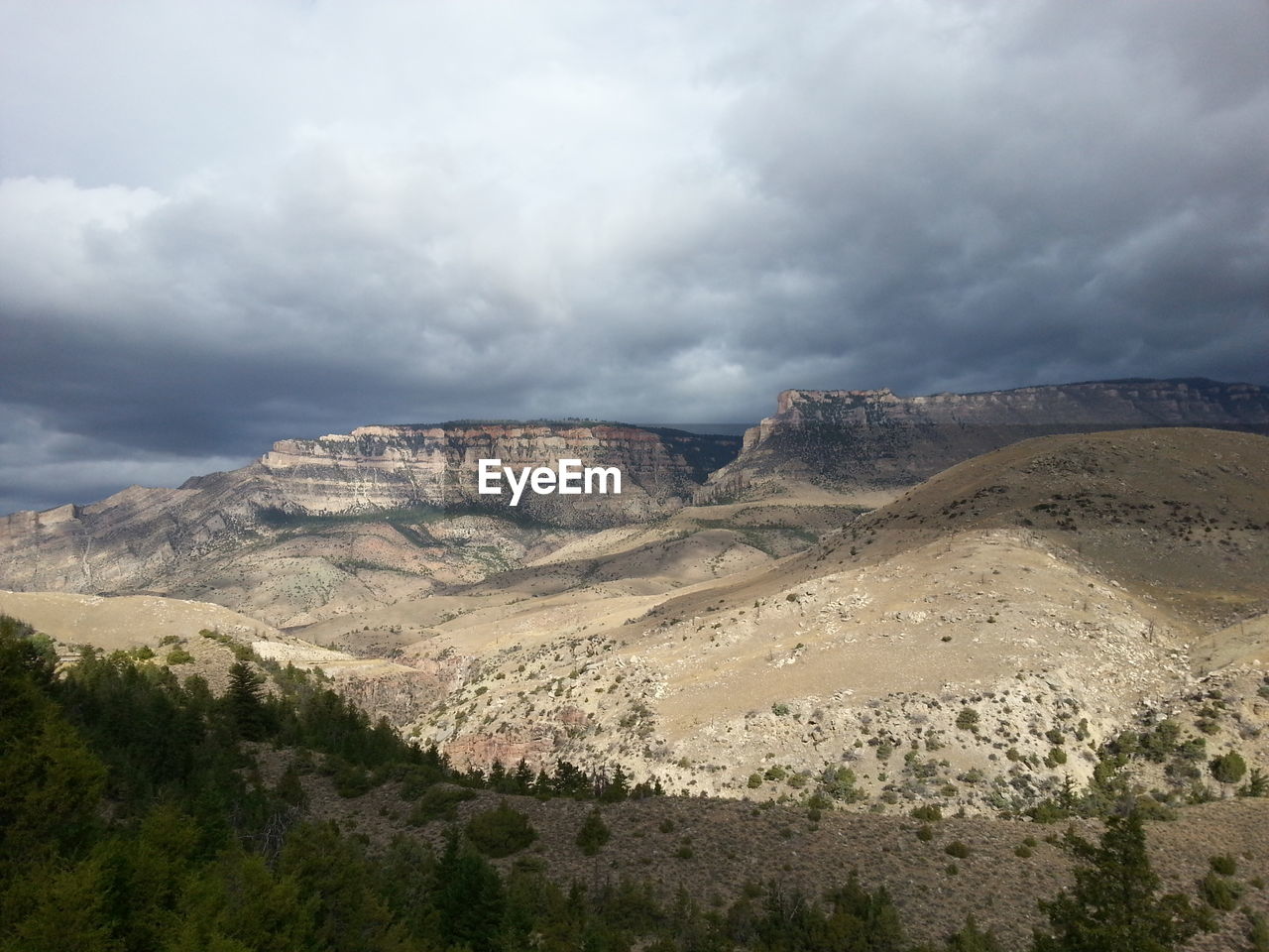 Scenic view of rocky mountains against cloudy sky