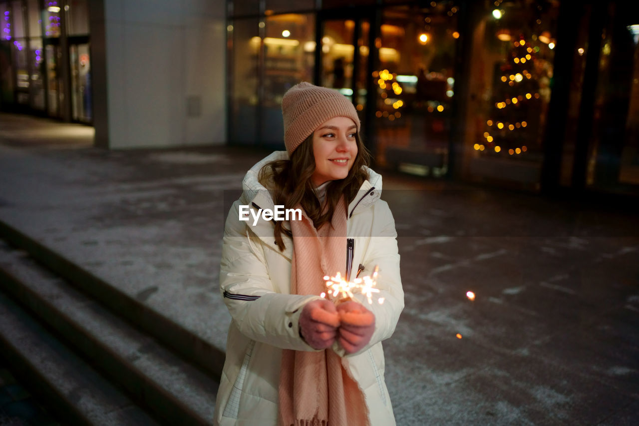 Caucasian white girl with sparklers christmas shopping