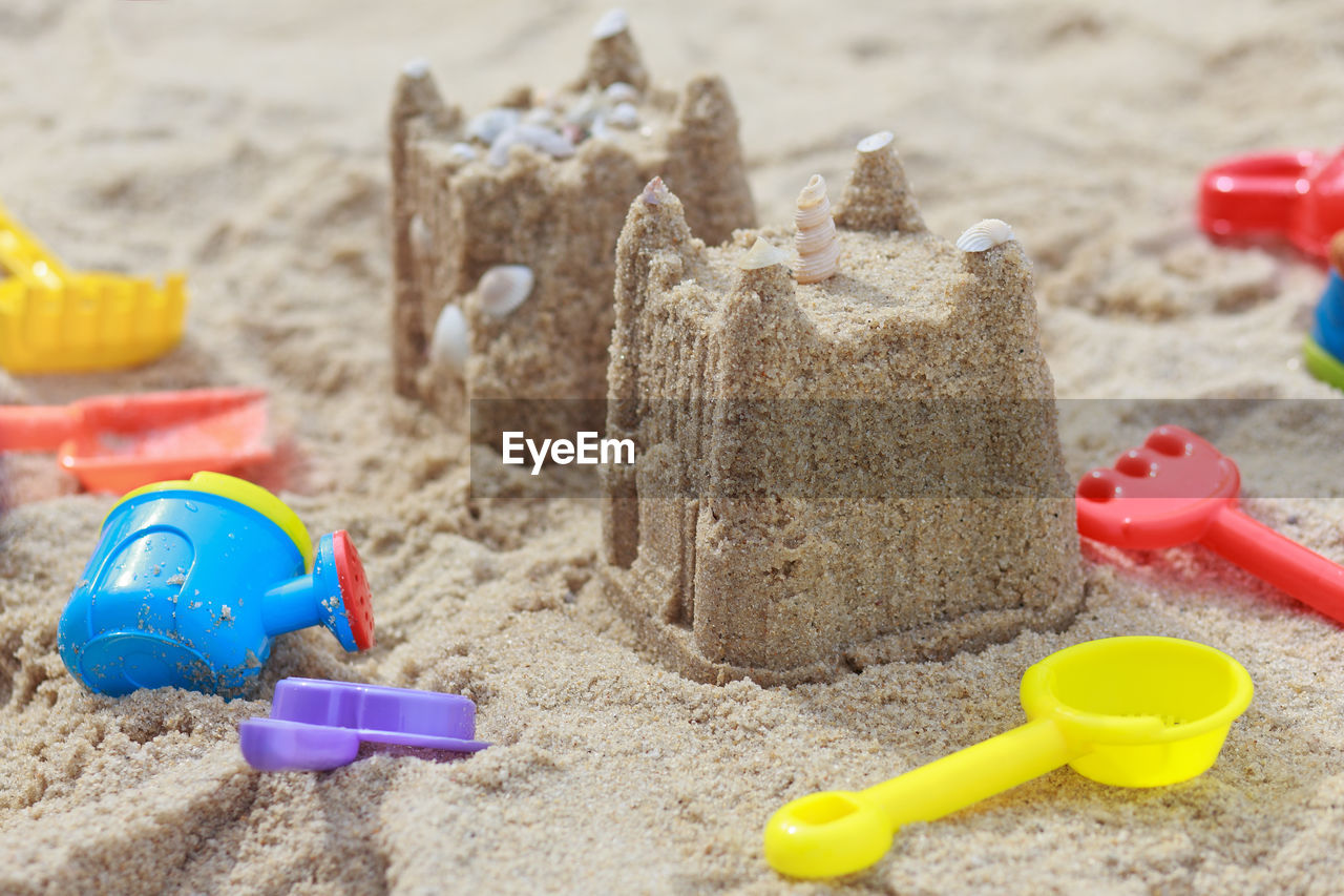 Close-up of sandcastles on beach