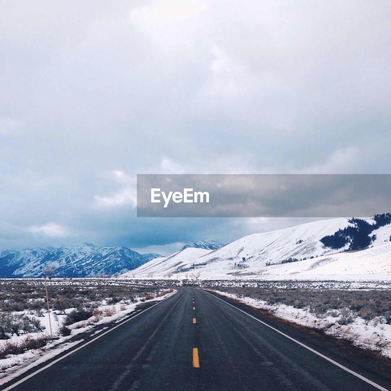 Road along snowcapped mountain range