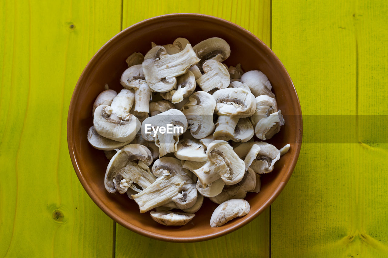 Directly above shot of chopped mushrooms in bowl on table