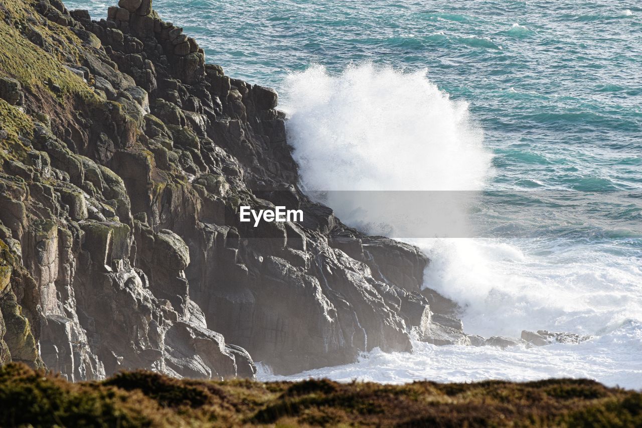 Sea waves splashing on rocks