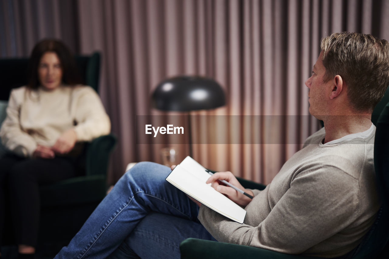 Male doctor and female patient at therapy session