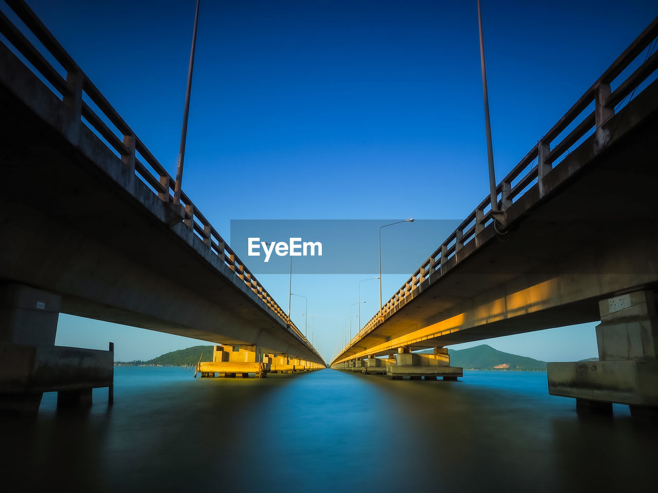 Low angle view of suspension bridge against sky