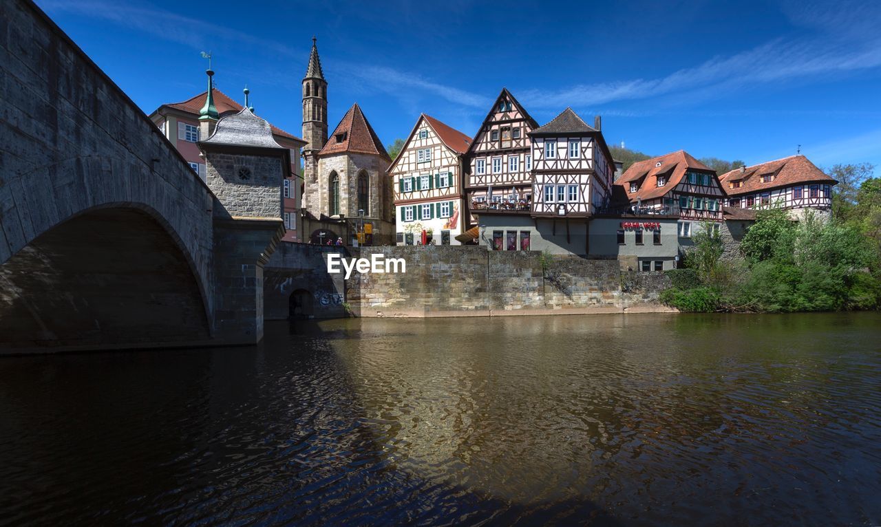 Bridge over river against buildings in city