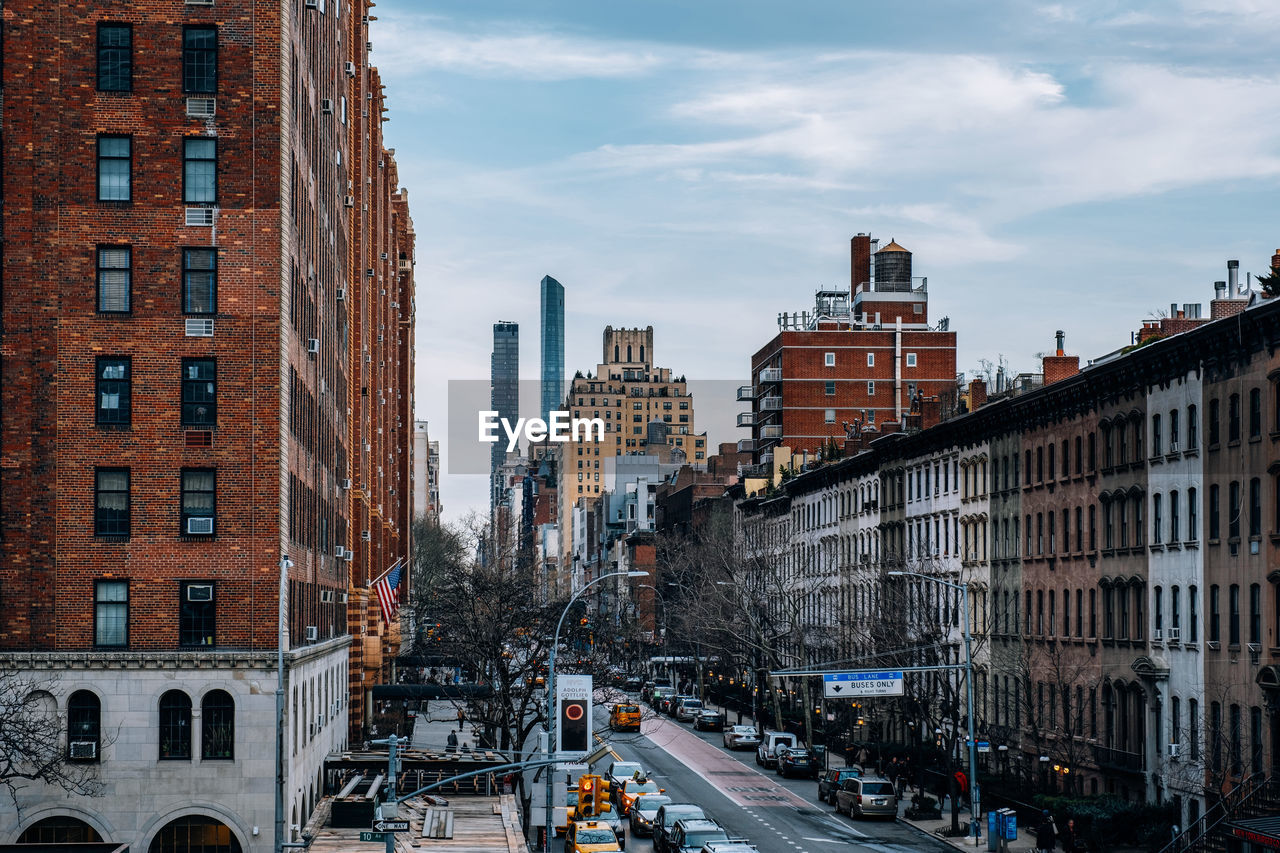 High angle view of street amidst buildings against sky