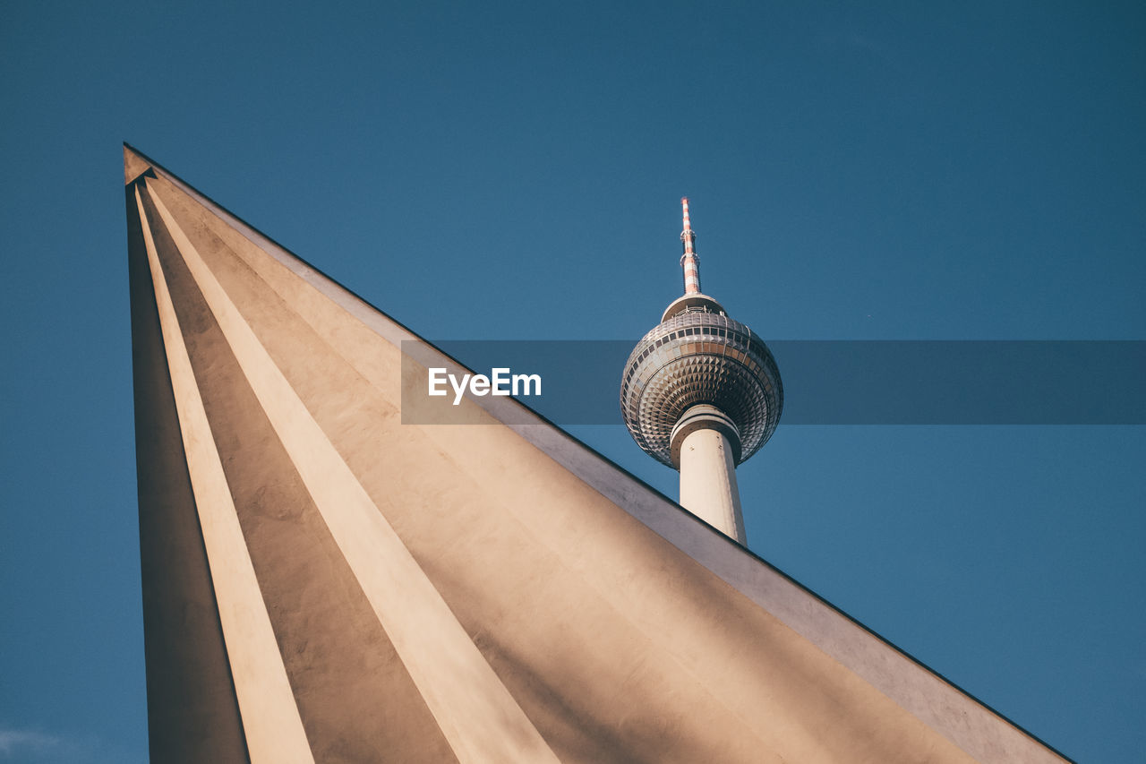 Low angle view of fernsehturm against clear blue sky