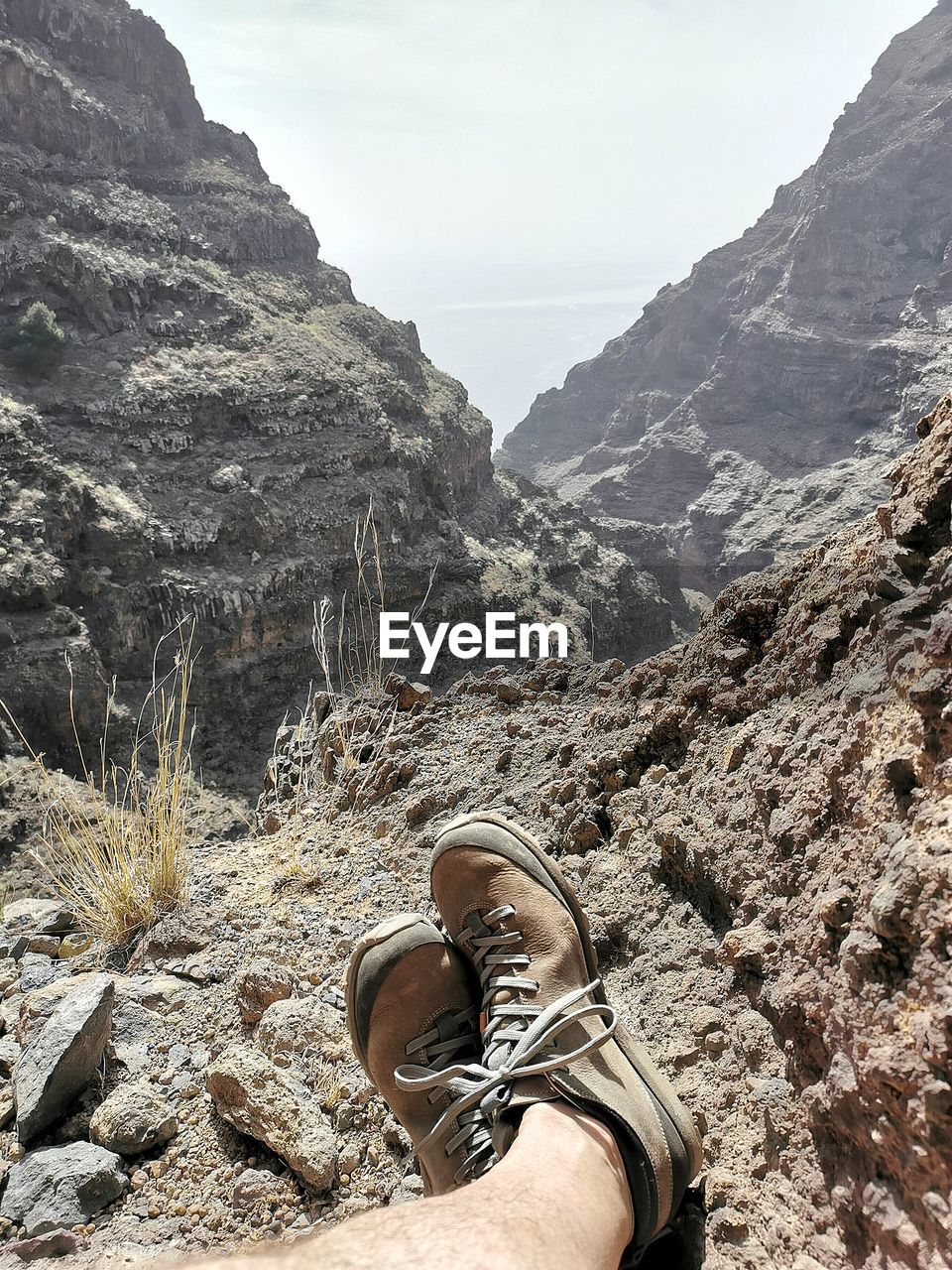 Low section of person on rock in mountains