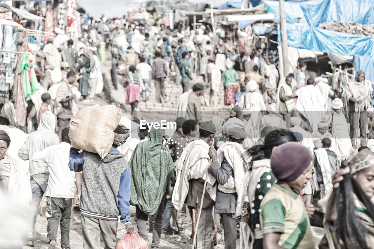 PEOPLE WALKING ON STREET IN CITY