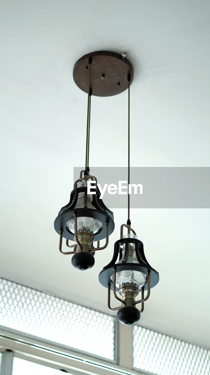 Low angle view of light bulbs hanging from ceiling