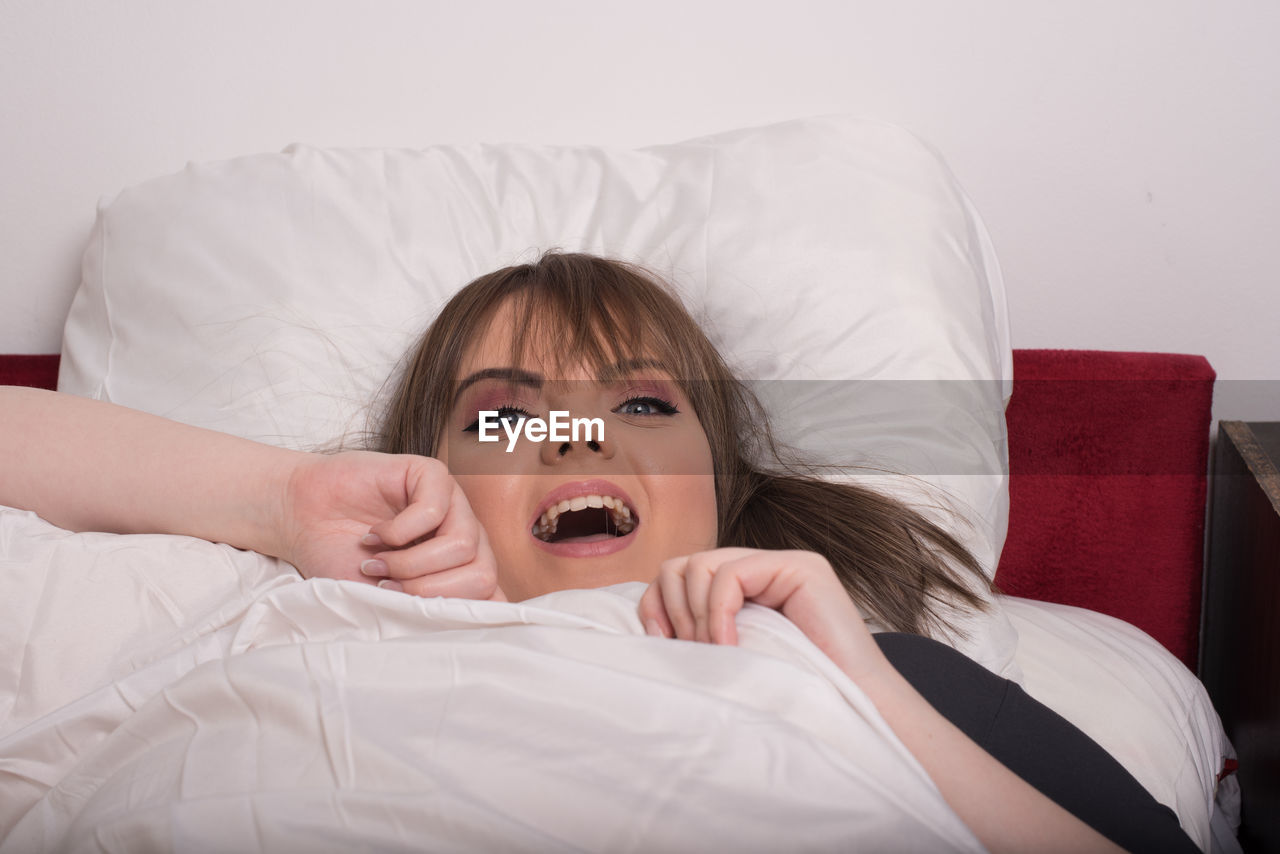 Young woman lying on bed at home