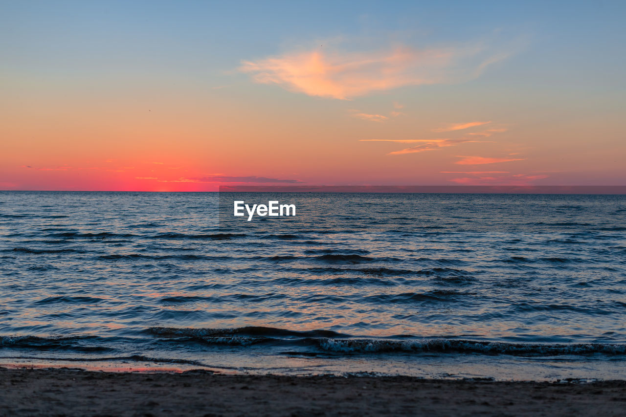 SCENIC VIEW OF SEA AGAINST ORANGE SKY