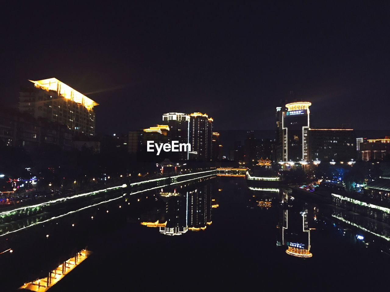 ILLUMINATED CITYSCAPE AGAINST SKY AT NIGHT