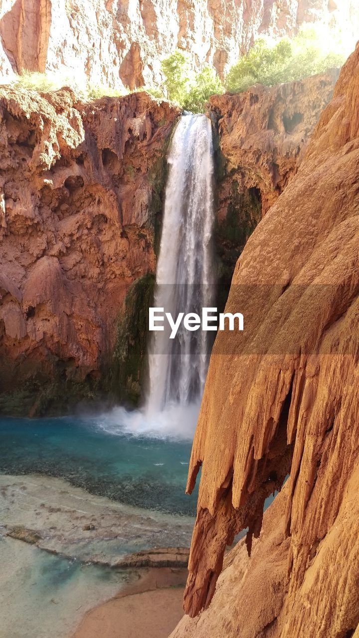 VIEW OF WATERFALL ON ROCKS