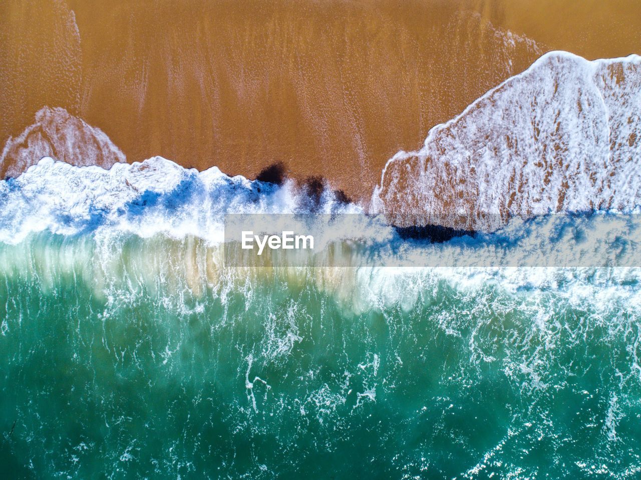 Aerial view of sea waves at beach