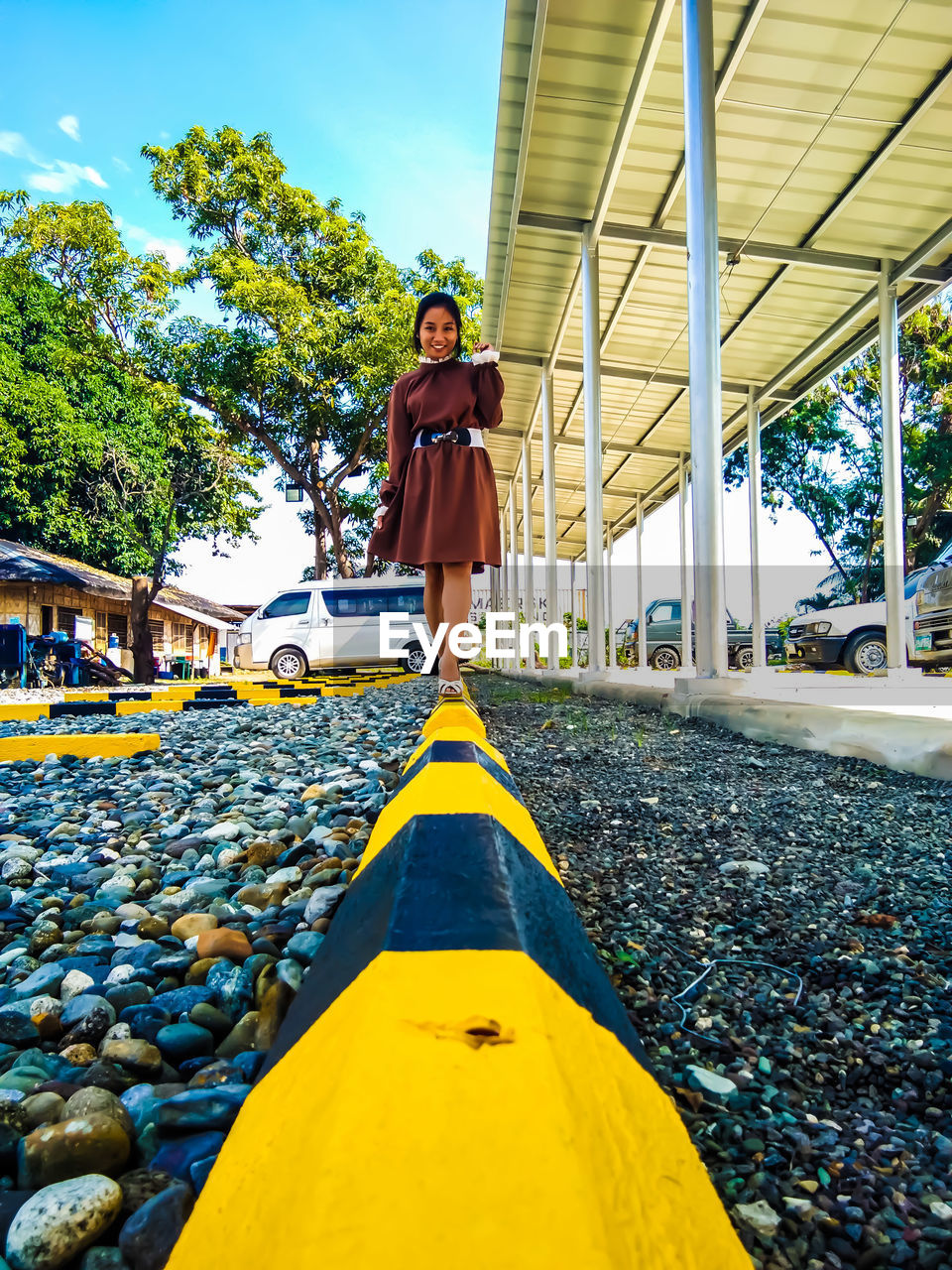 Low angle view of young woman walking on painted blocks