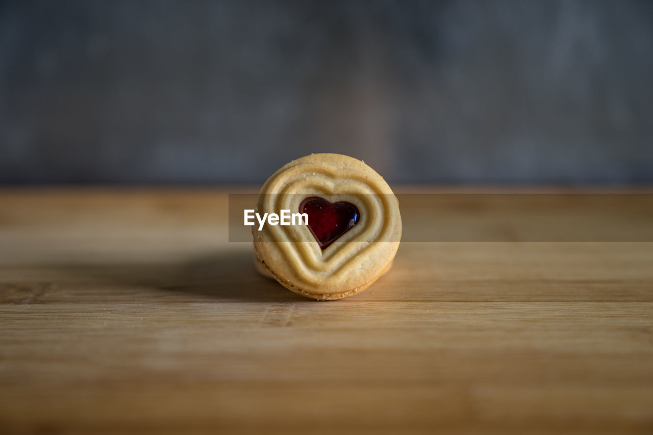 Close-up of heart shape sweet food on wooden table