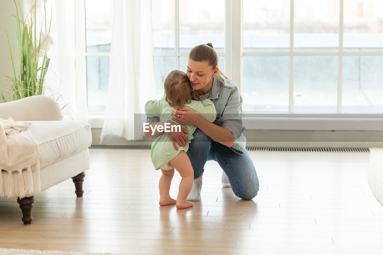 side view of young woman exercising on floor at home