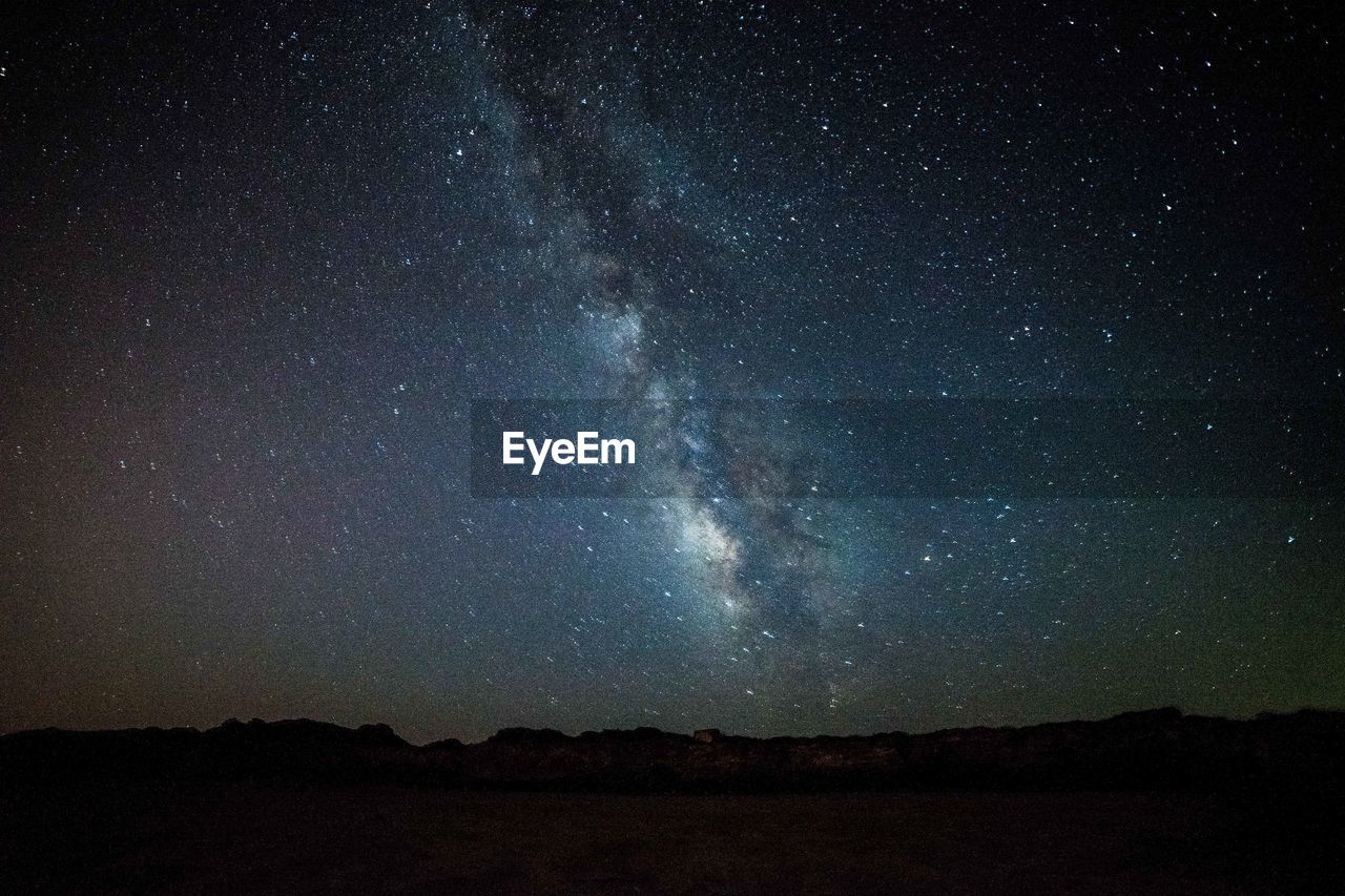 low angle view of silhouette landscape against sky at night