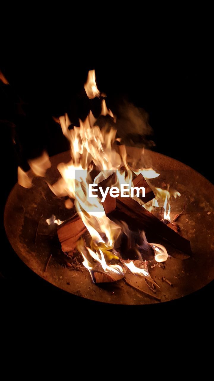 High angle view of illuminated fire pit at night