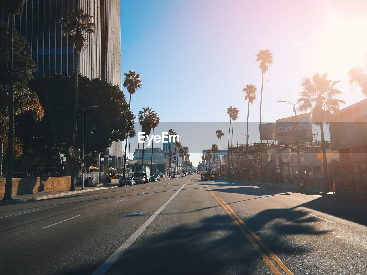 Road by buildings in city of los angeles, usa against sky