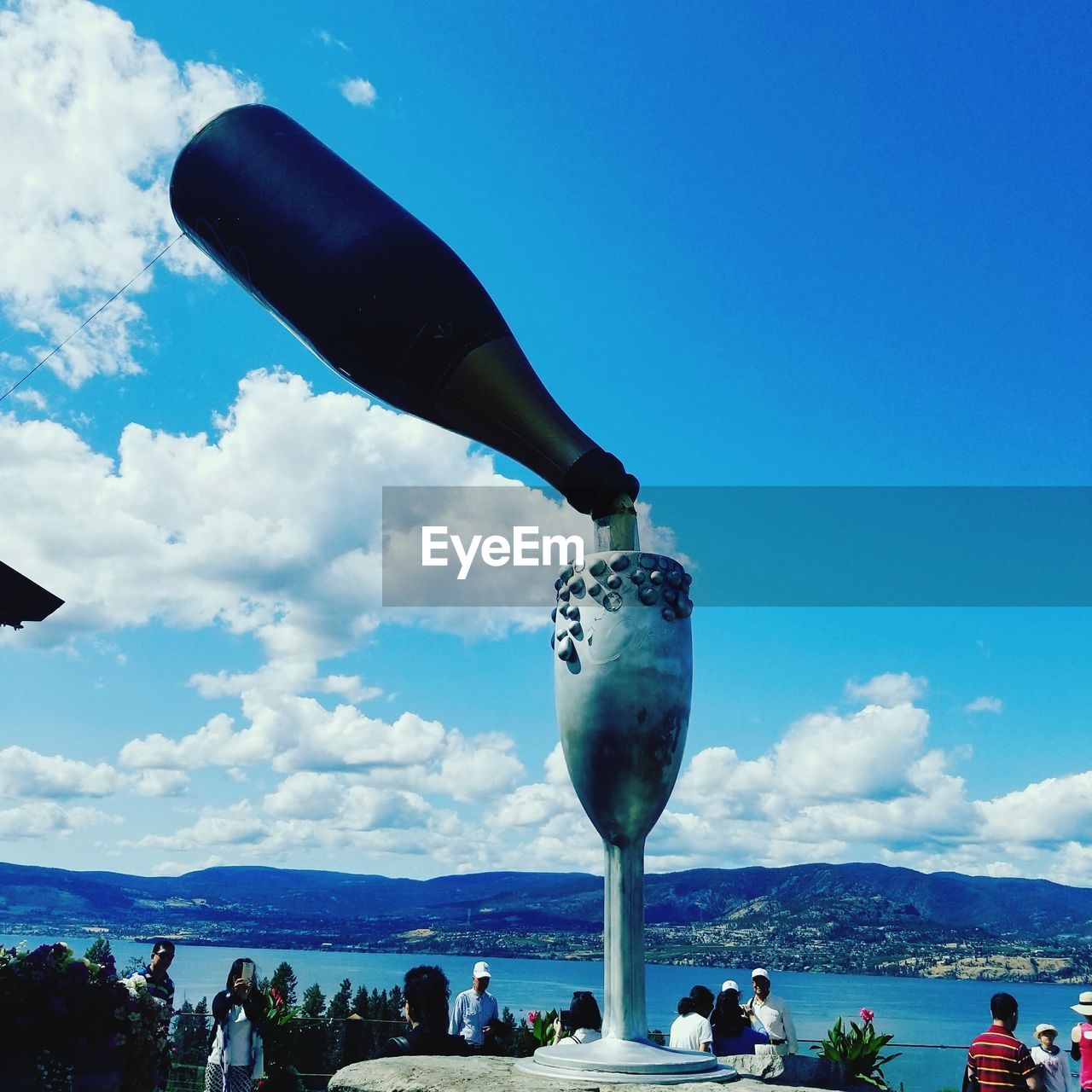 PEOPLE IN SEA AGAINST BLUE SKY