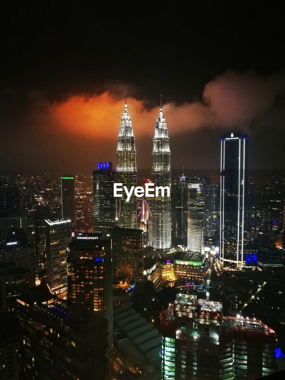 ILLUMINATED BUILDINGS AGAINST SKY AT NIGHT