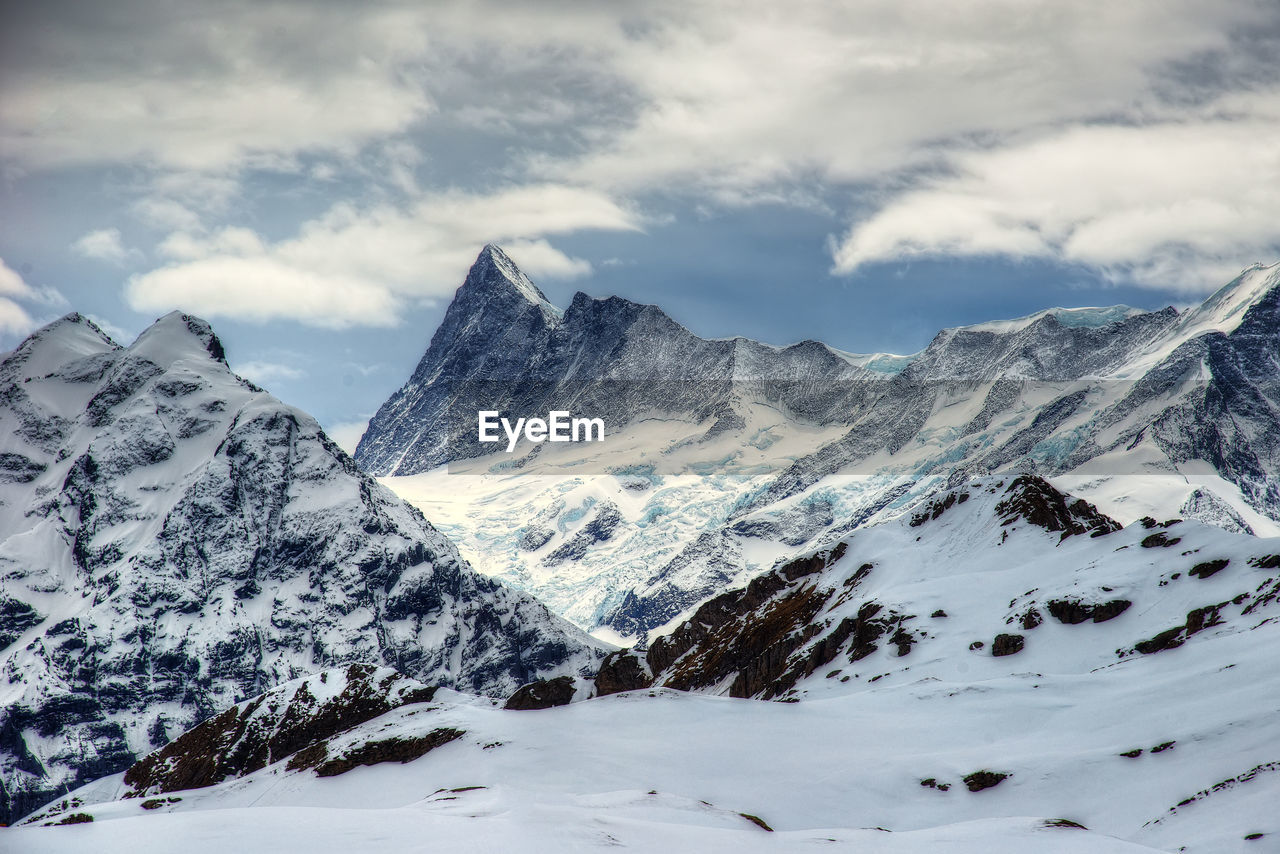 Scenic view of snowcapped mountains against sky