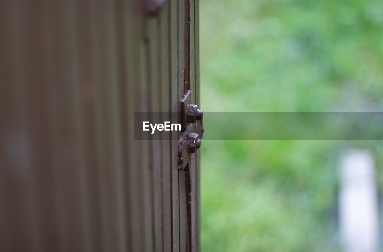 CLOSE-UP OF METAL DOOR ON FENCE